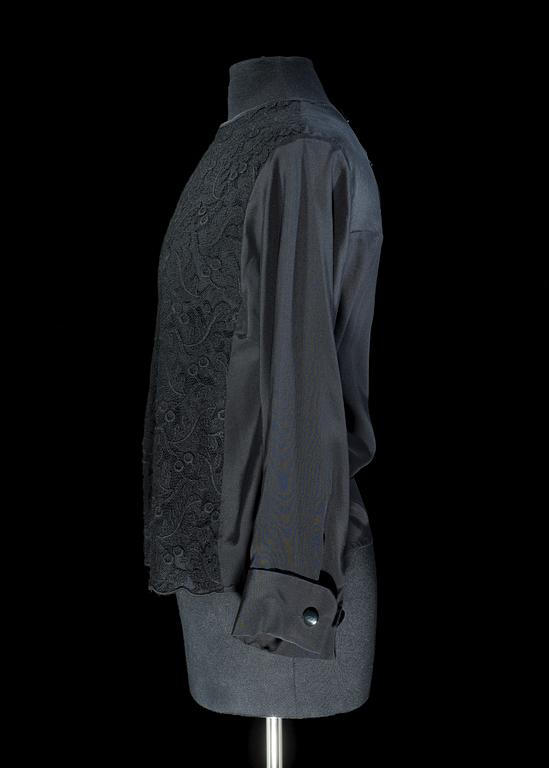 A black silk lace blouse by Yves saint Laurent.
