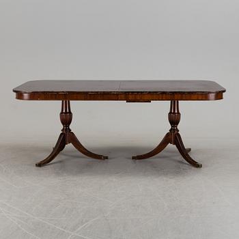 A second half of the 20th century mahogany  dining table with 5 additional leaves.