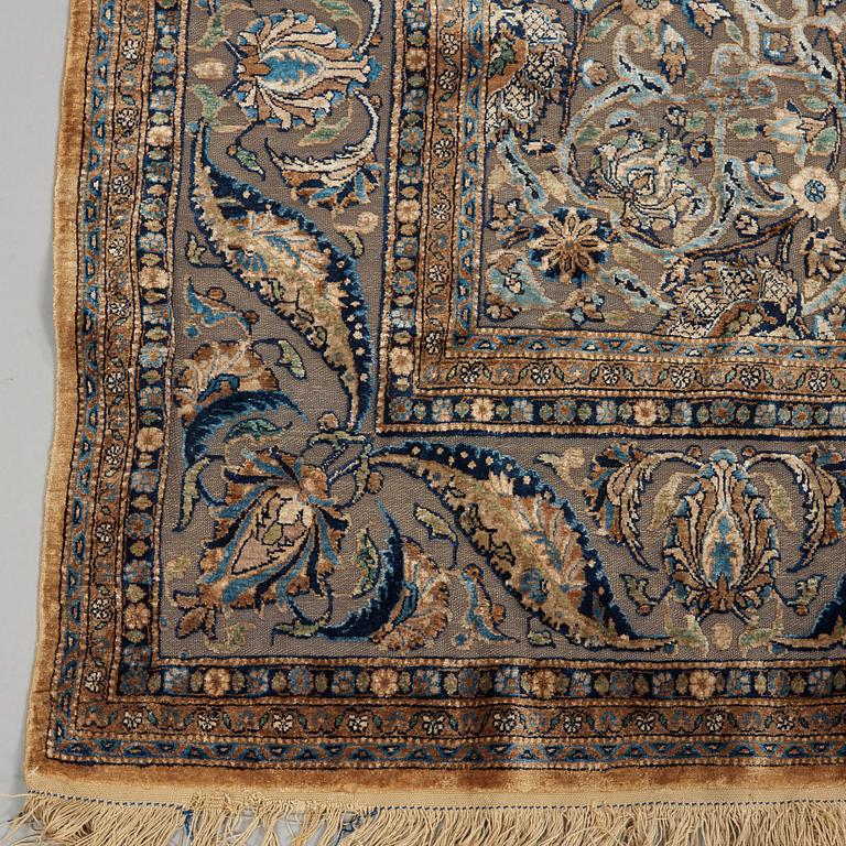 A RUG. A semi-antique silk Kashan Souf (in relief). 210 x 131,5 cm (as well as one cm flat weave at each end).