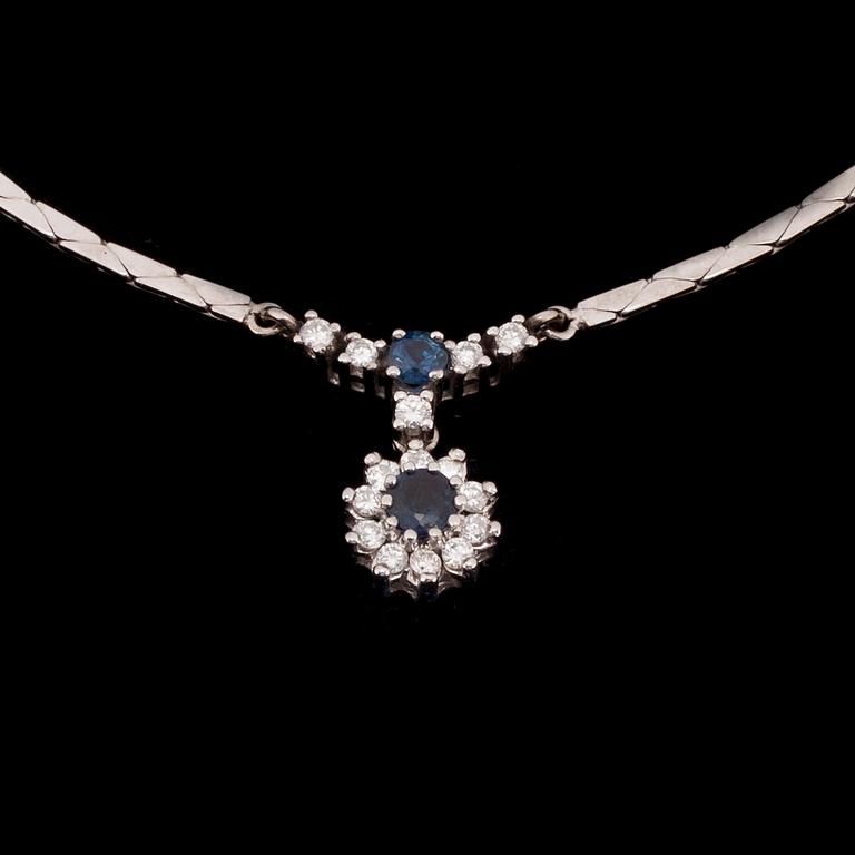 HÄNGSMYCKE, 14K vitguld, 2 safirer, diamanter tot. 0,30 ct. Vikt 10,9 g.