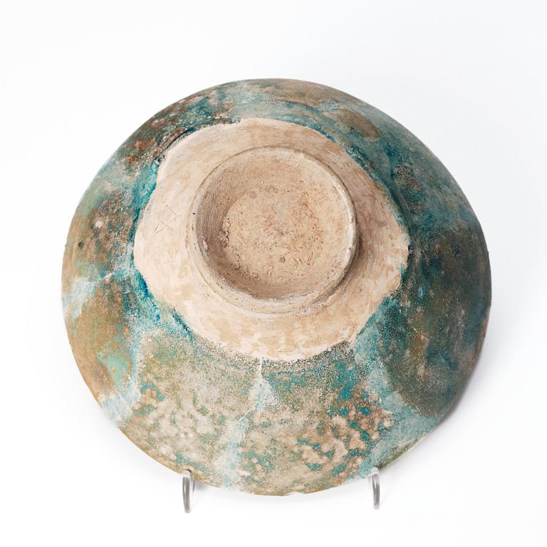 A 10-11th century Kashan Turquoise-glazed pottery bowl.