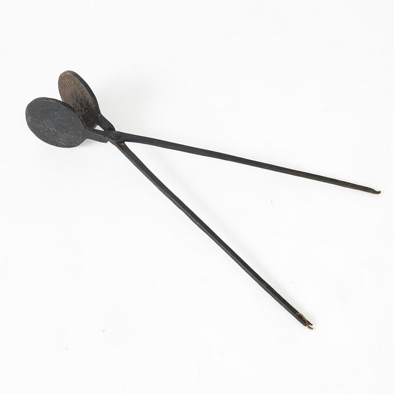 An iron wafer maker, dated 1662.