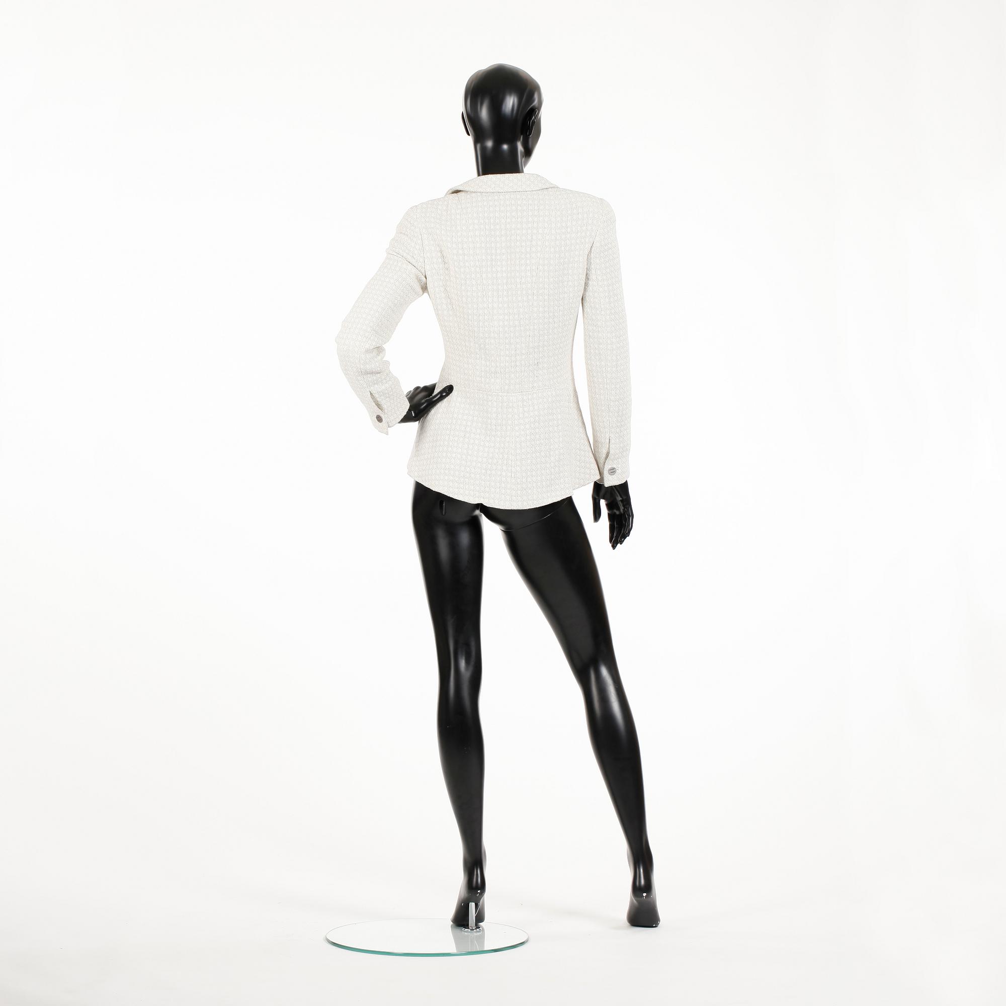 CHANEL, a white bouclé jacket.