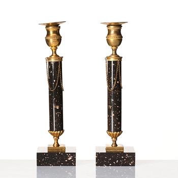 A pair of late Gustavian porphyry and gilt brass candlesticks, circa 1800.