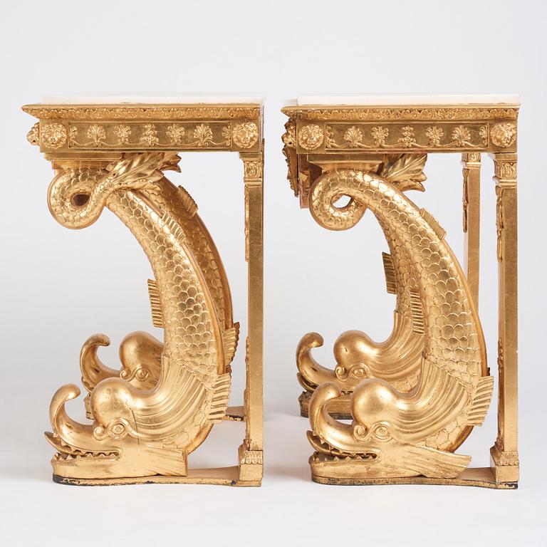 A pair of Swedish Empire carved and giltwood console tables, first half of the 19th century.