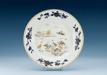 1379. A grisaille and underglaze blue charger, Qing dynasty, Qianlong (1736-95).