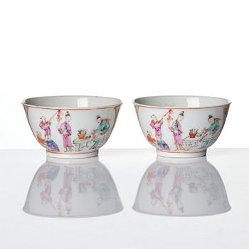 A pair of famille rose 'figural' tea cups with saucers, Qing dynasty, Qianlong (1736-95).