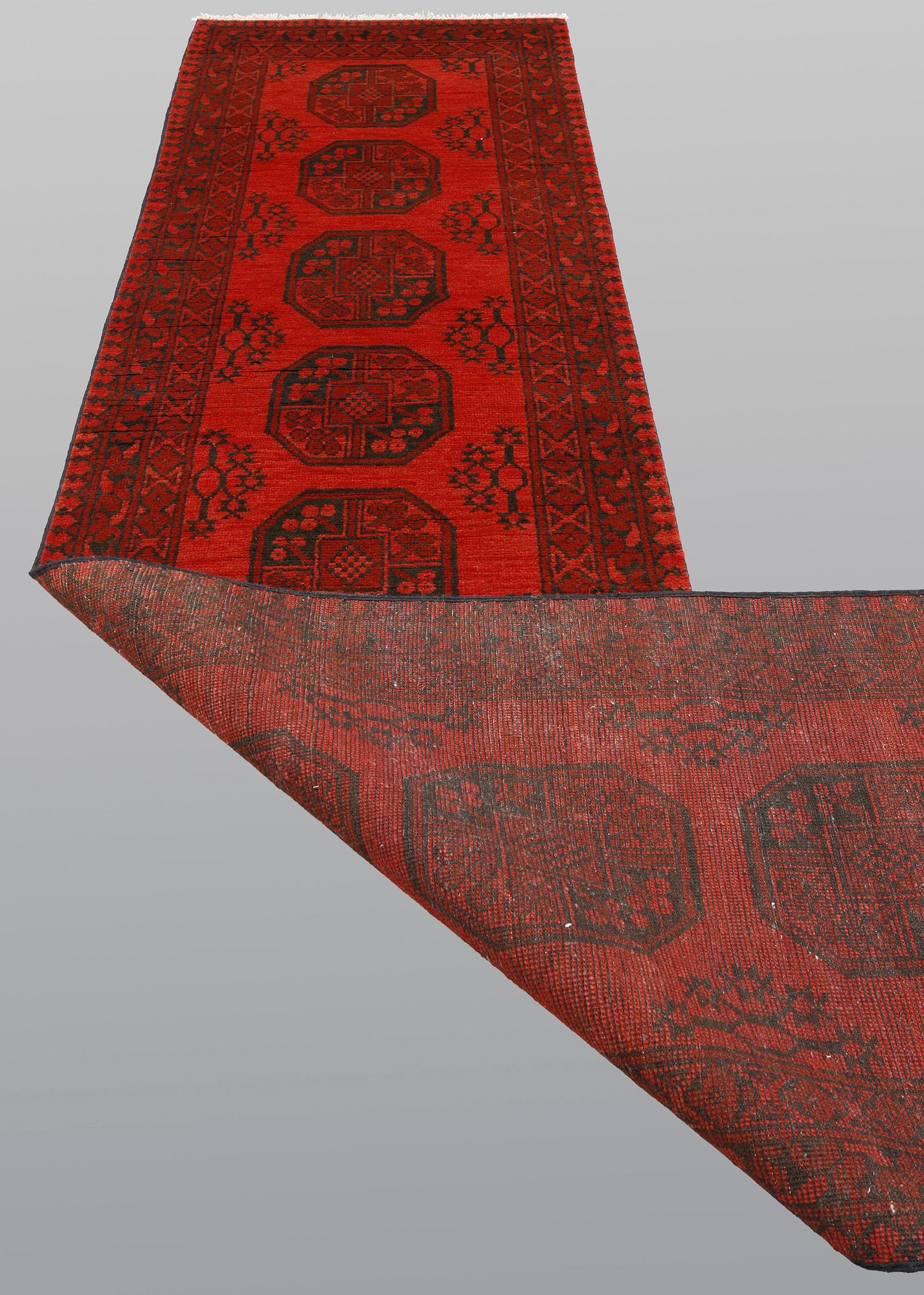 An Afghan runner, ca 390 x 79 cm.