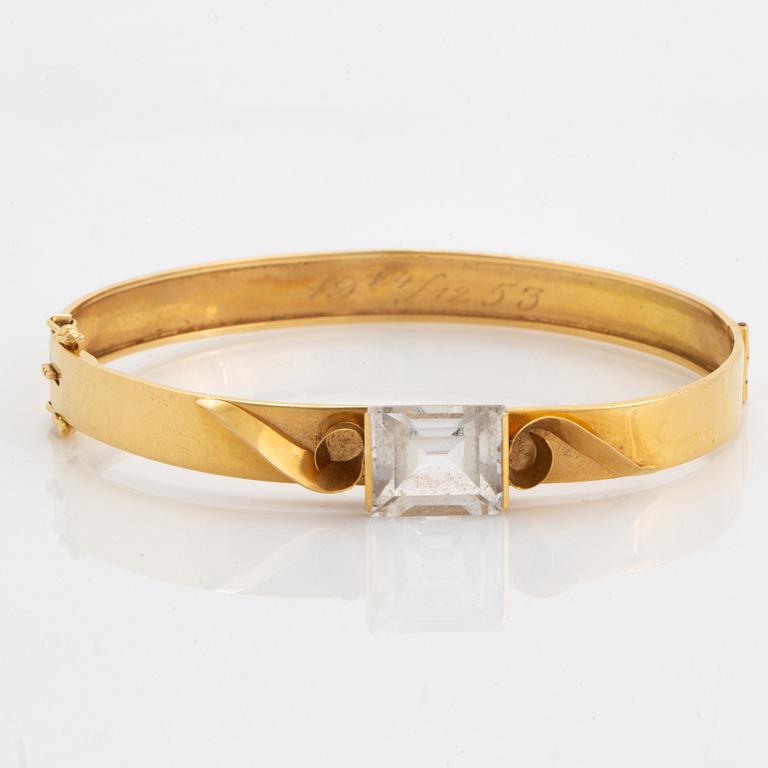 18K gold bangle and white synthetic stones.