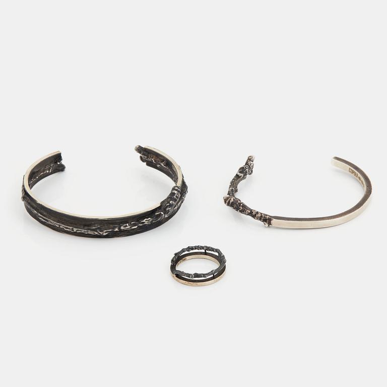 Two Copula silver bracelets and a ring.