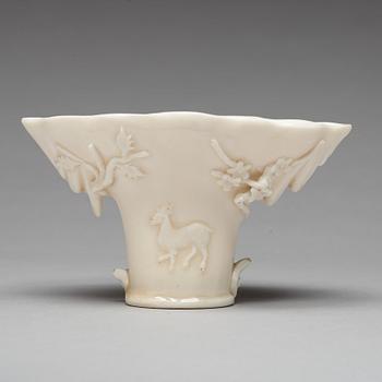 A blanc de chine rhinoserous shaped libation cup, 17th Century.