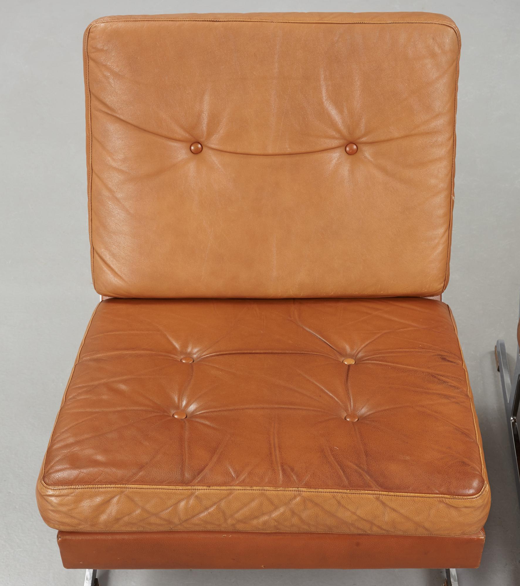 A pair of Poul Nørreklit chromed steel and brown leather easy chairs, Selectform, Denmark 1960's.
