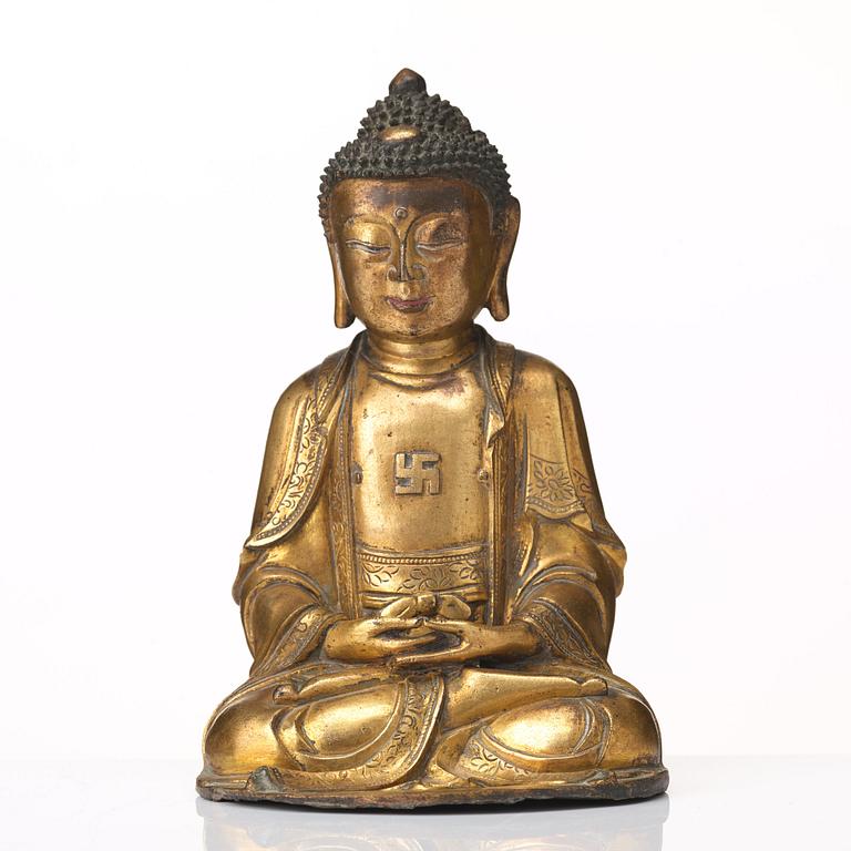 A gilt bronze figure of Amithaba Buddha, Ming dynasty (1368-1644).