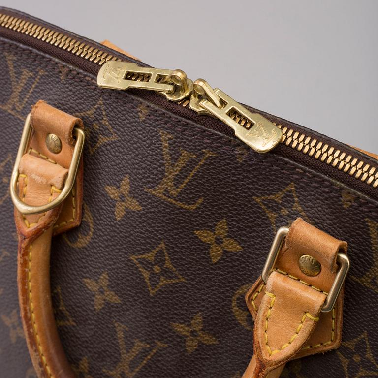 An 'Alma' handbag by Louis Vuitton dated 1997.