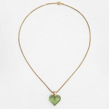 A Lalique heart pendant with an 18K gold chain.
