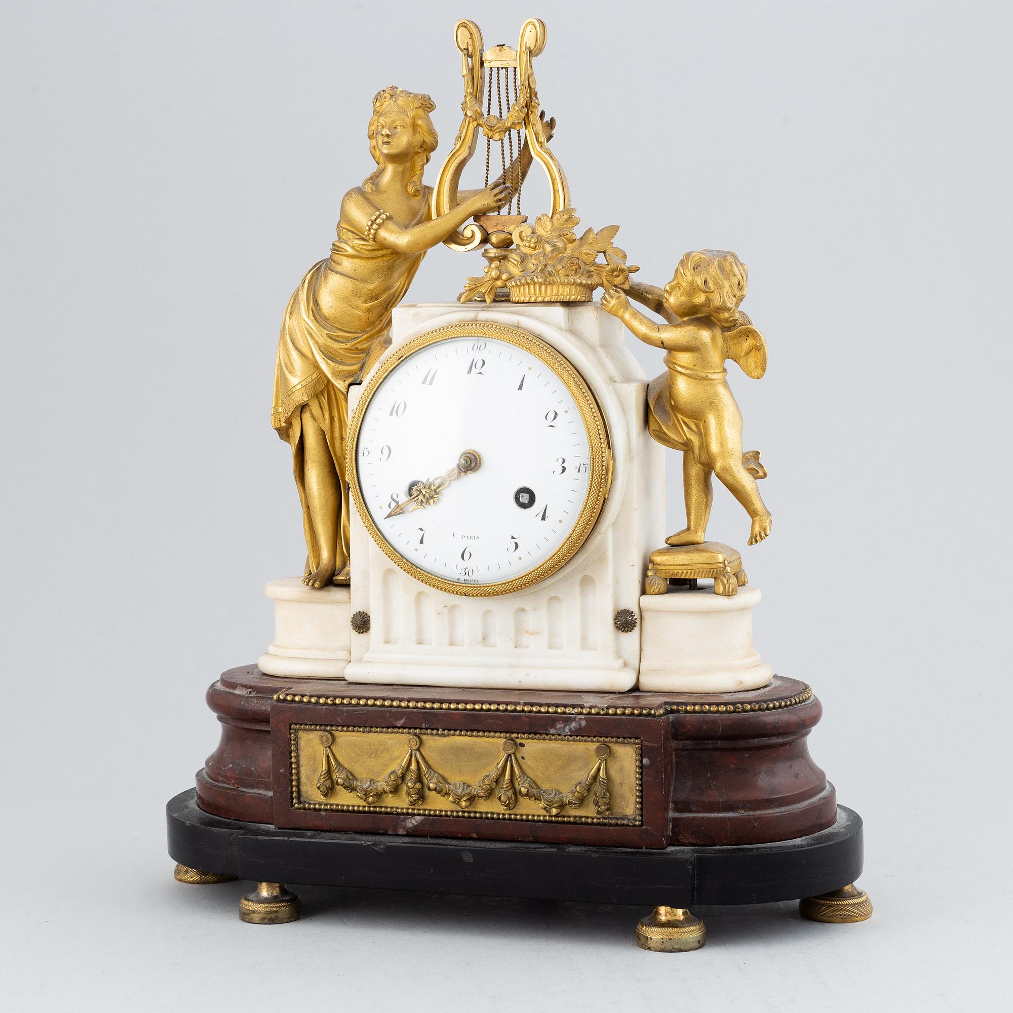 A 19th-century Louis XVI-style mantle clock.