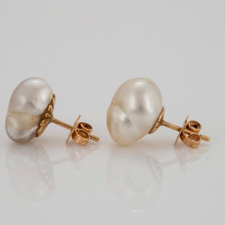 A pair of 18K gold earrings set with baroque pearls.