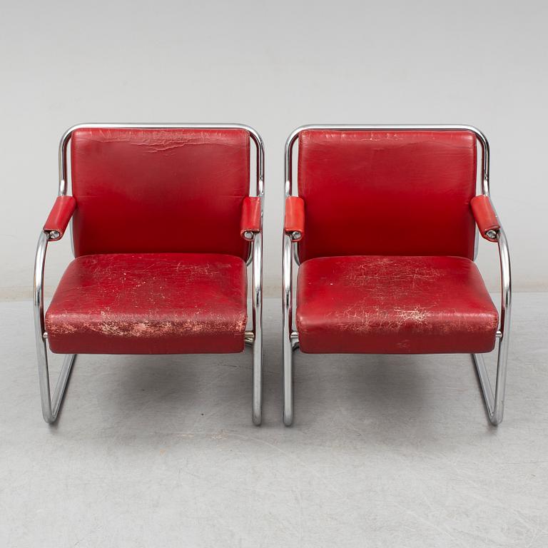 A pair of 1920s armchairs.