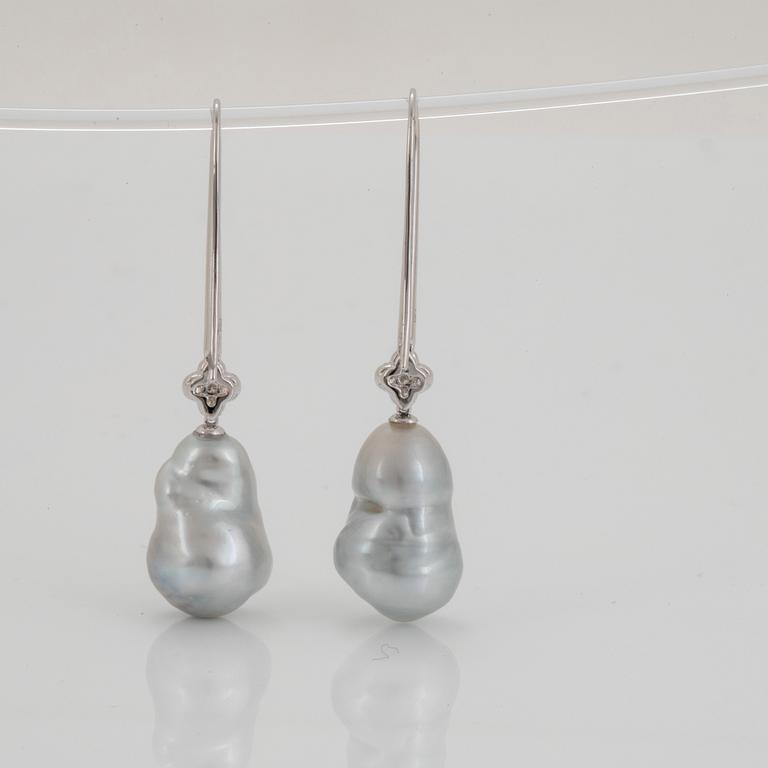 A pair of cultured South Sea pearl earrings in 18K white gold set with round brilliant-cut diamonds.