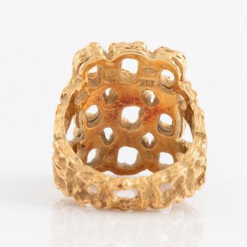 A Gilbert Albert ring in 18K gold.