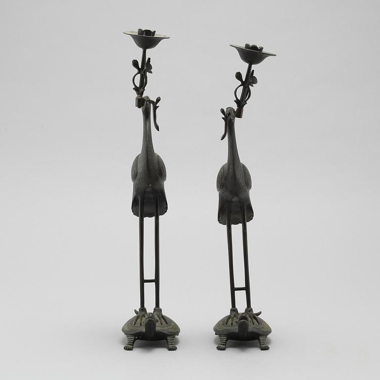 A pair of bronze candlesticks, China, 20th Century.