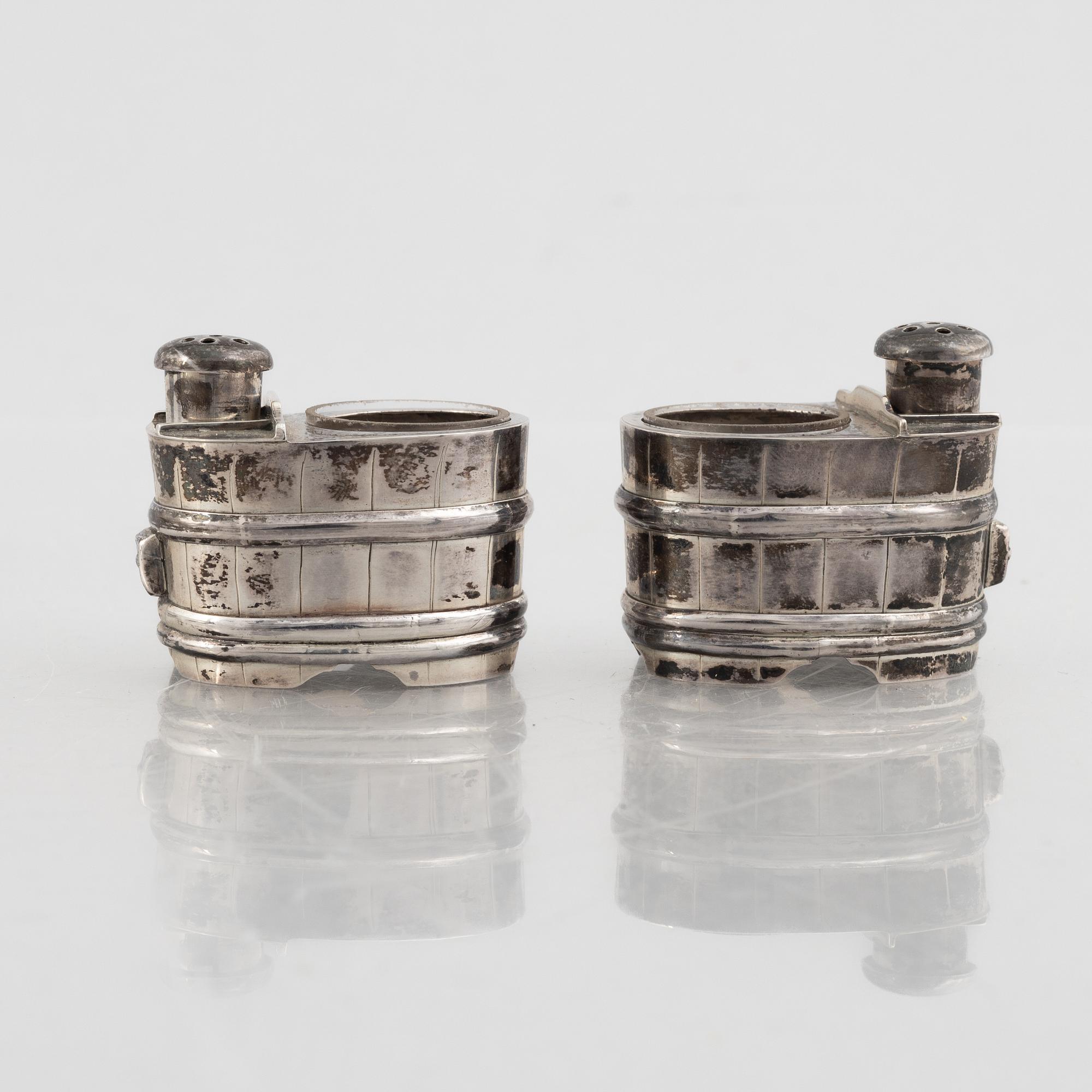 A set of three Japanese silver coasters and a pair of salts with shakers, 20th century.