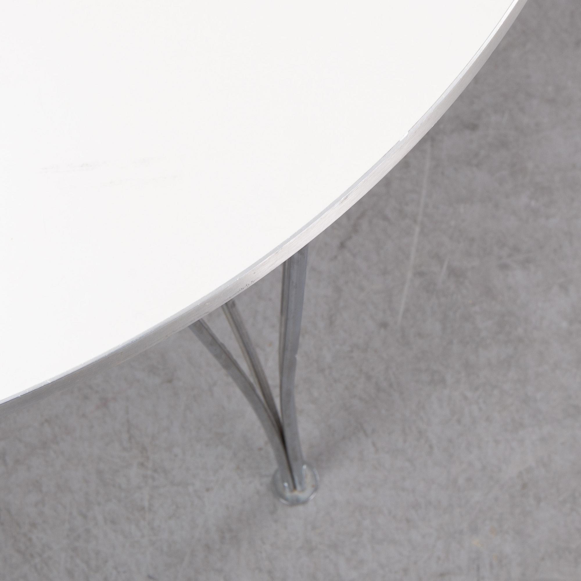 A 'Supercircle table by Bbruno Marthsson & Piet Hein for Fritz Hansen, dated 2000.
