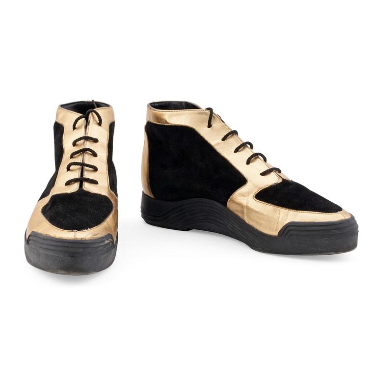 CHARLES JOURDAN, a pair of black suede and gold colored leather sneakers.