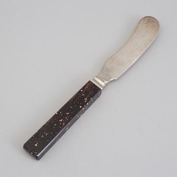 A silver butterknife with porphyry shaft, dated 1853.