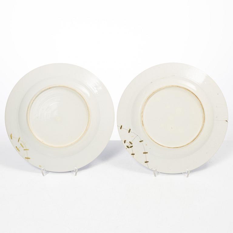 A pair of armorial dinner plates, soft paste, Qing dynasty, 18th century.