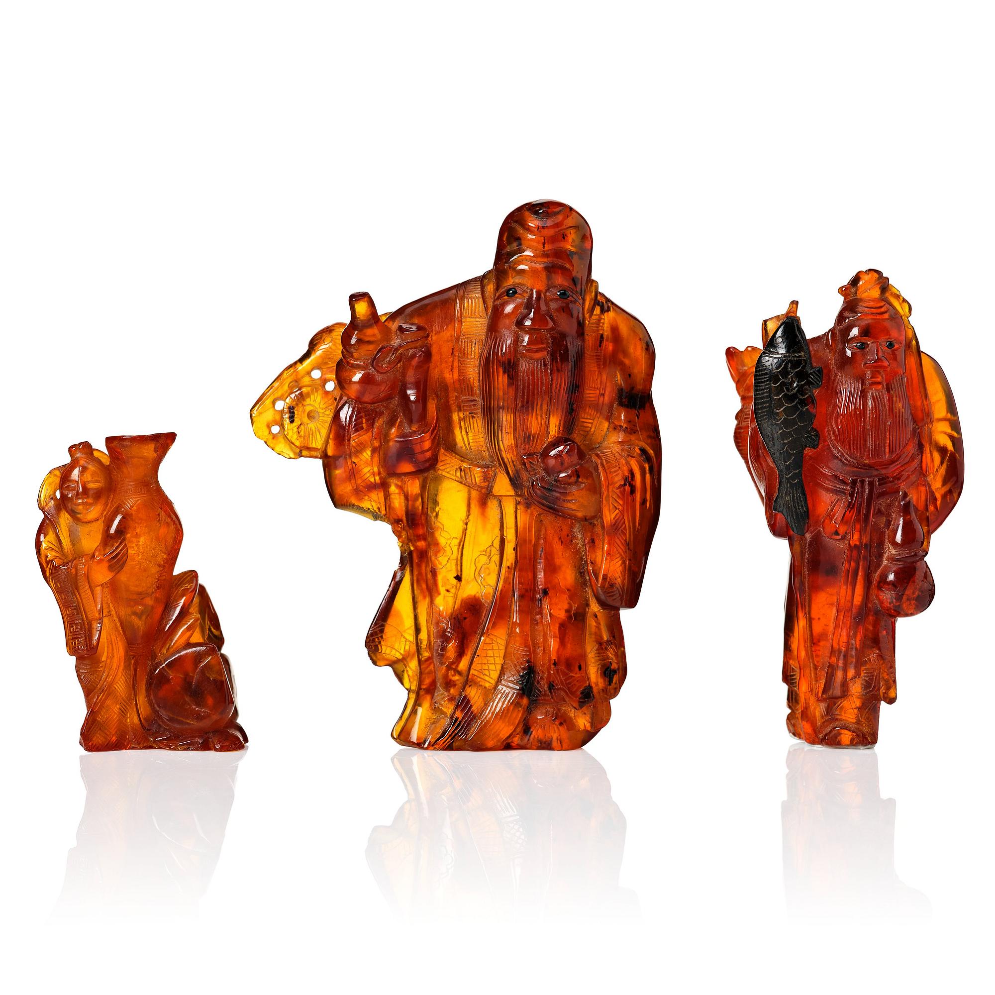 A group of three amber scultpures, late Qing dynasty/early 20th Century.