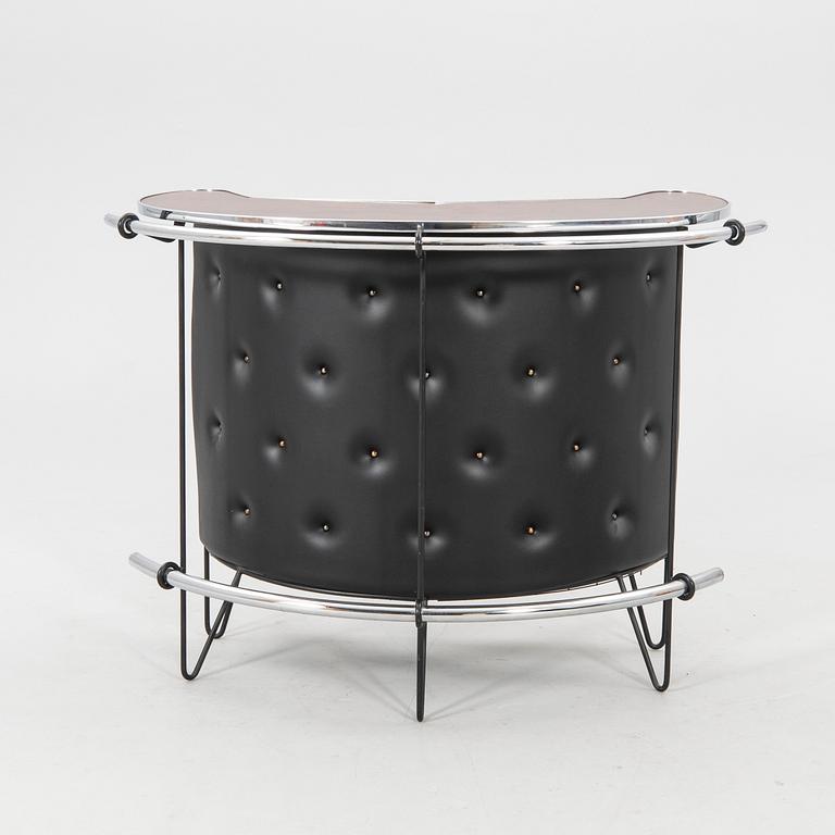 A 1970s bar and four stools.