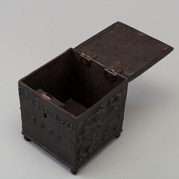 An empire cast iron tobacco box, dated 1838.