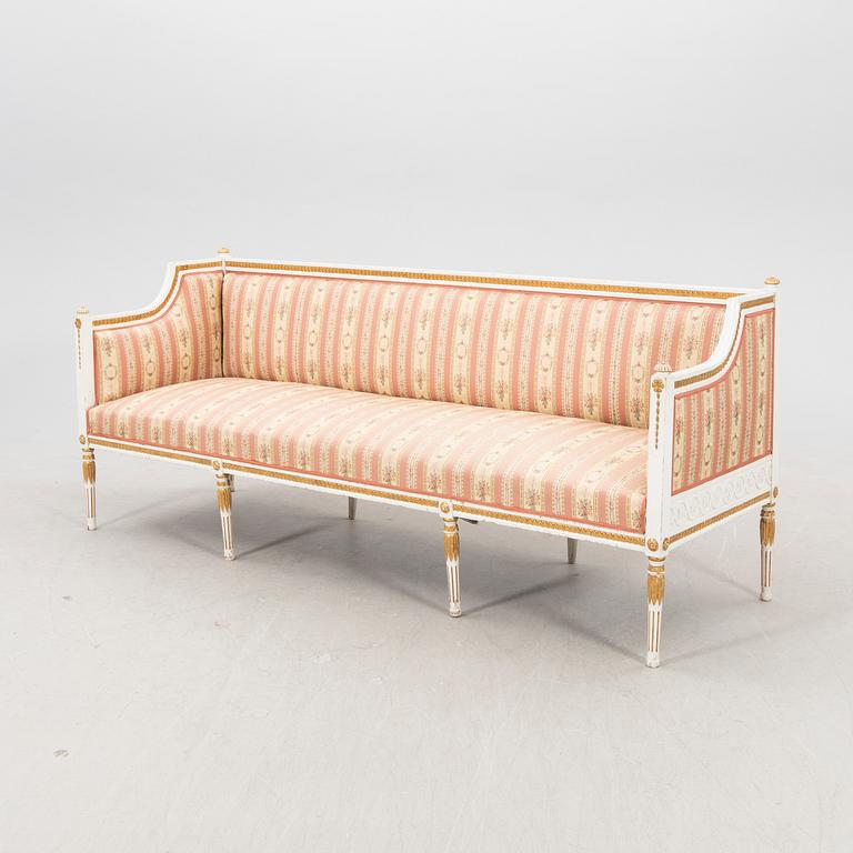 A painted and guilded late gustavian sofa from the 19th century.
