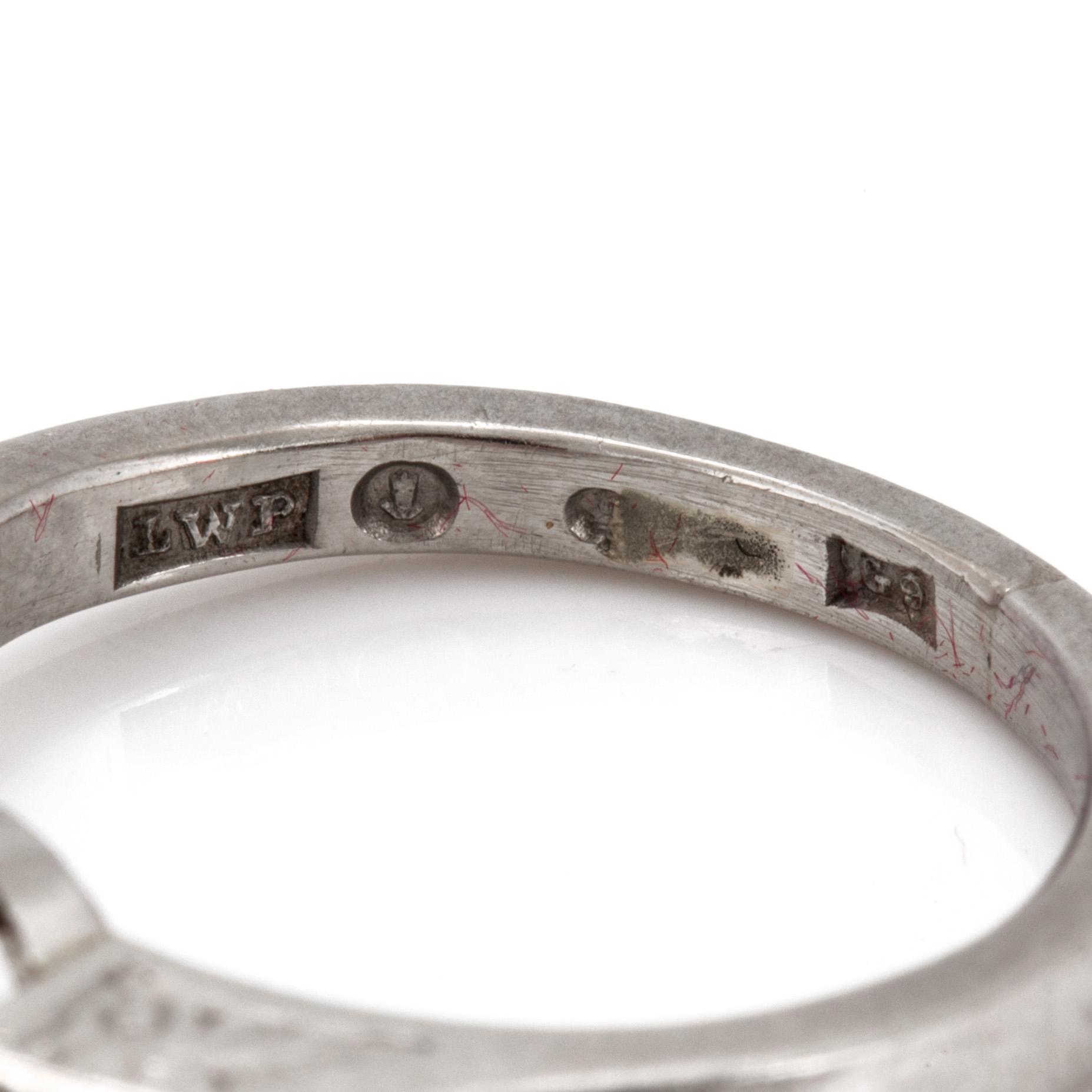 A ring set with a round, brilliant-cut diamond and two baguette-cut diamonds to the shoulders.