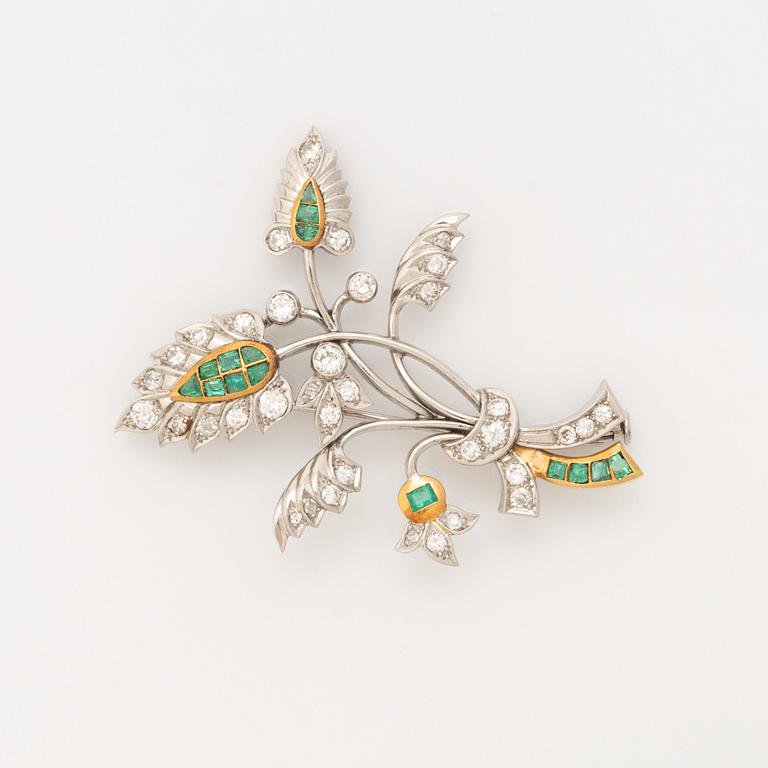 Platinum and gold with brilliant cut diamonds and emerald brooch.