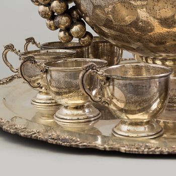 A first half of the 20th century silver punch bowl with twelve cups.