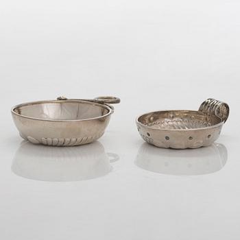 Two French silver taste du vin cups, 1819-38 and early 20th century.