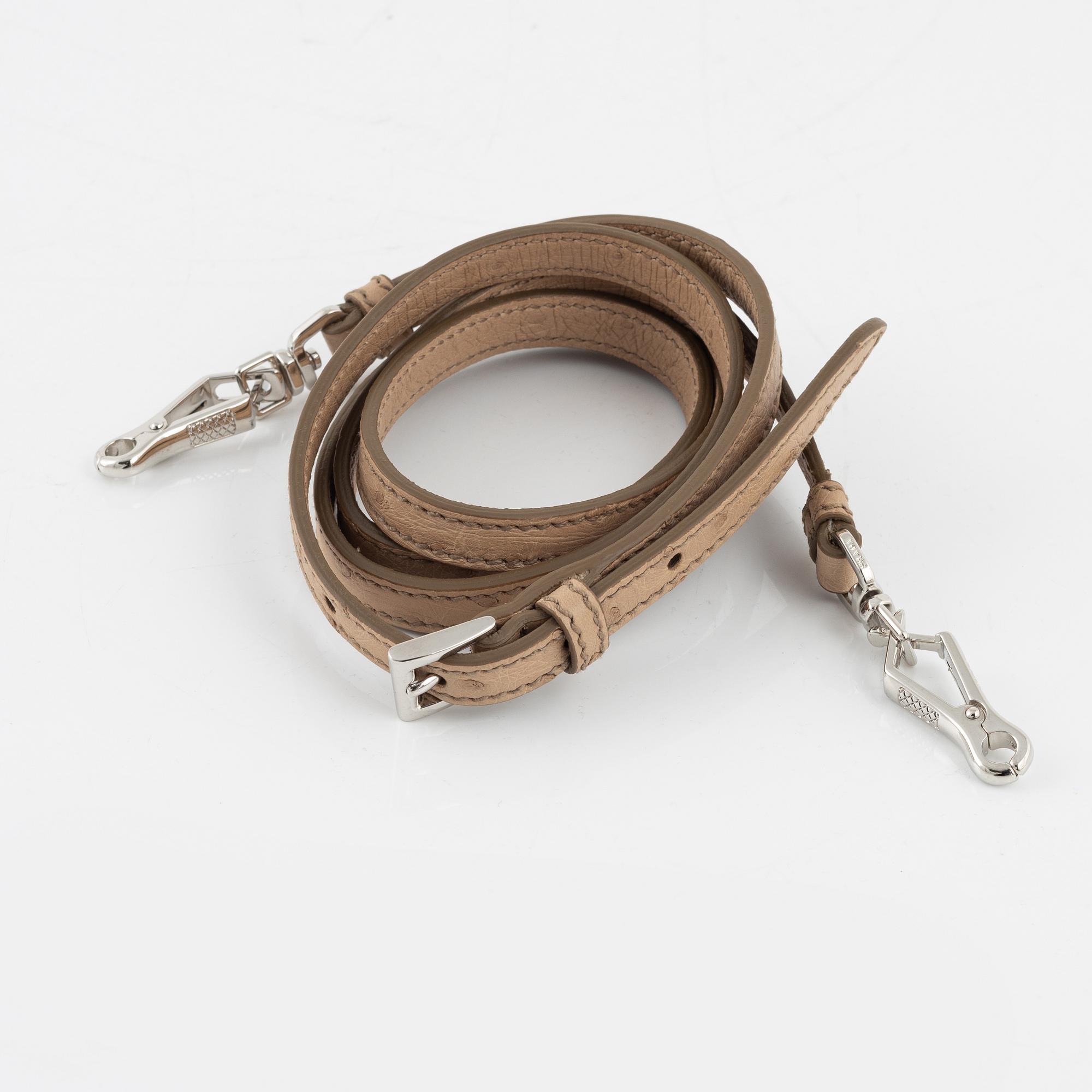 Prada, a beige ostrich leather bag.