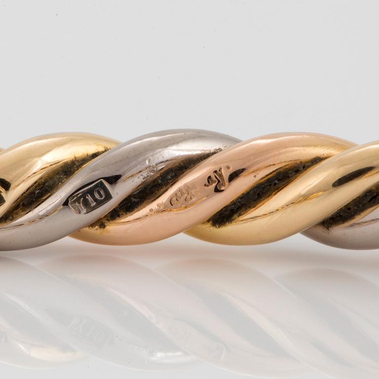 A Gaudy bangle in 18K tri color gold.