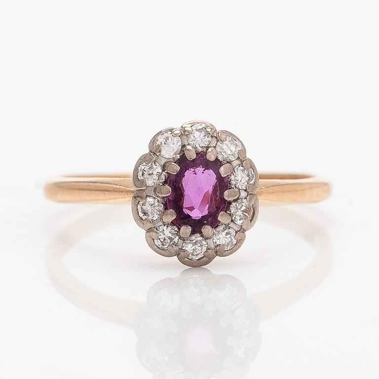 A 14K gold ring, with a pink sapphire and diamonds.