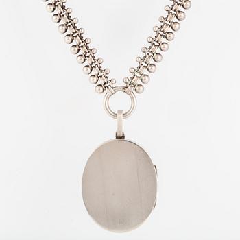 A LOCKET with partly silver and enamel.
