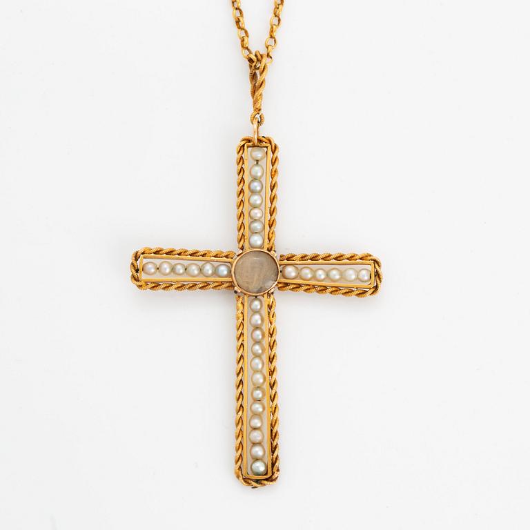 An 18K gold and pearl cross pendant with a gold chain.