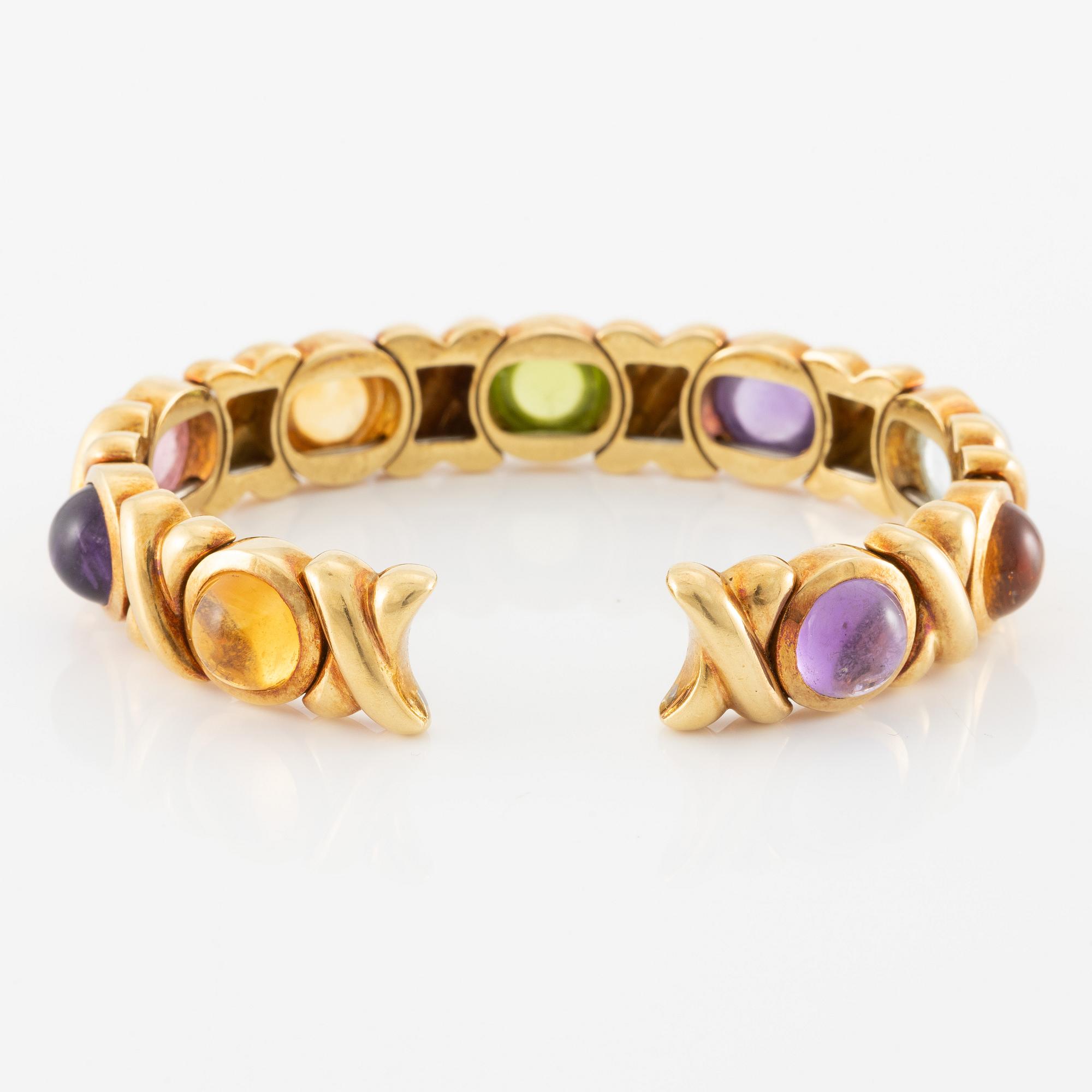 Bracelet in 18K gold set with cabochon-cut citrine, amethyst, pink tourmaline, peridot, and aquamarine.