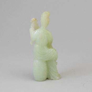 An early 20th century Chinese serpentine stone figure of an elegant lady.