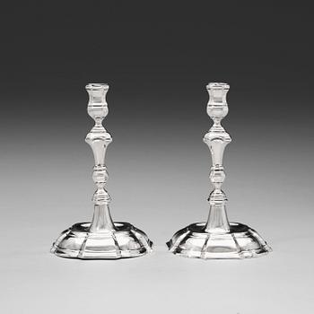 1037. A pair of 18th century silver candlesticks, unidentified makers mark WP.