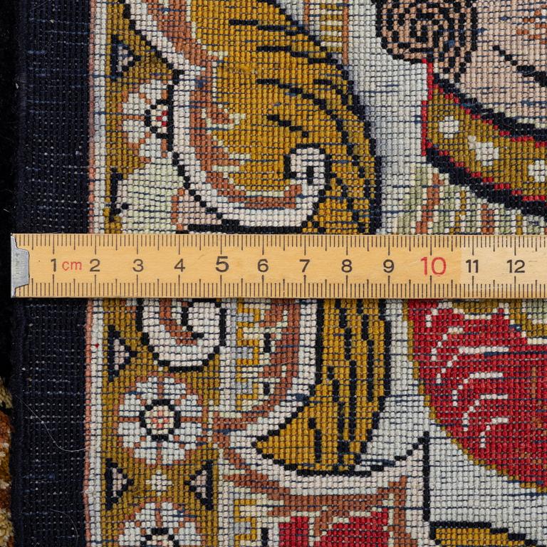 A pictorial semi-antique silk Qum rug, central Persia, c. 214 x 146 cm.