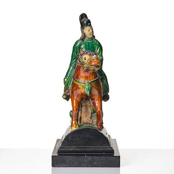 A Chinese glazed stoneware ridge tile figure of a mandarin official on a horse, Ming dynasty (1368-1644).