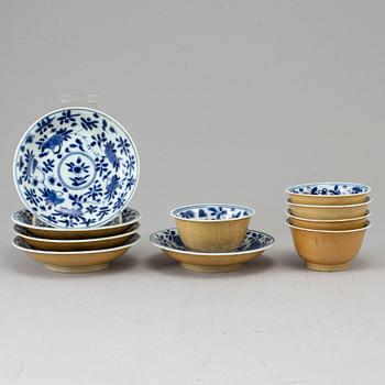 Five blue and white and cafe au lait glazed cups with dishes, Qing dynasty, Qianlong (1736-95).