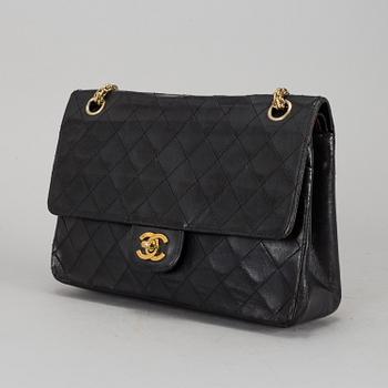 CHANEL, a quilted black leather 'Double Flap Bag'.